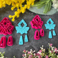 A set of bright pink and turquoise 3d printed polymer clay cutters arranged on a dark textured surface with decorative flowers around the edges. The set includes large fan-shaped stamping cutters, smaller matching cutters, and pointed cone-shaped cutters. First Light Polymer Clay Cutter Set
