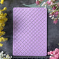 A rectangular lavender purple silicone stamp with a raised trellis pattern, displayed on a dark gray textured background and surrounded by yellow and pink flowers, with a ruler at the bottom indicating its 7cm width.